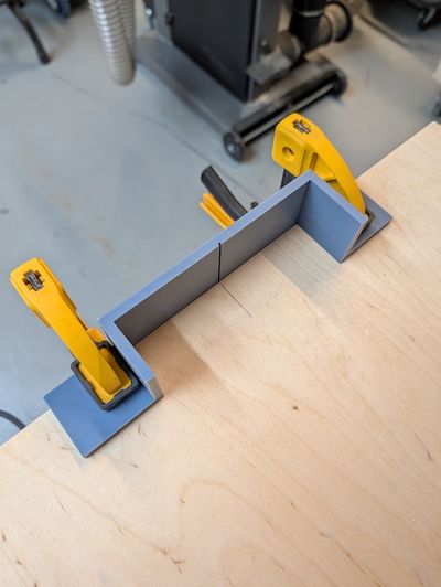 An image of the jig clamped against the piece being cut