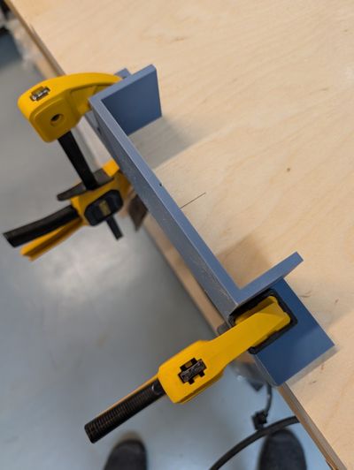 Another image of the jig clamped against the piece being cut