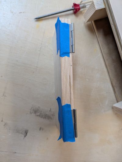 Taping the hinges to the top